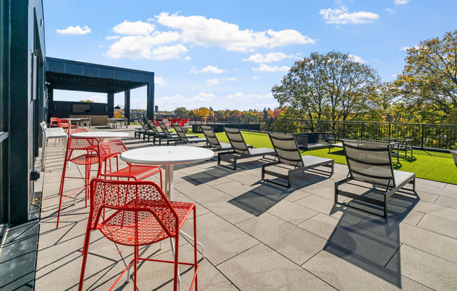 a patio with tables and chairs on a roof top patio
