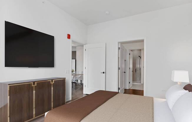 a bedroom with a bed and a tv on the wall at Cassidy on Canal, Chicago, IL