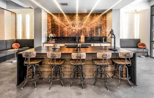 a large bar with bar stools in a room with a couch and a mirrorat The Overlook, Winter Garden, Florida