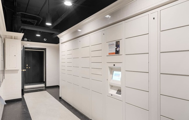a storage room with white cabinets and a black ceiling