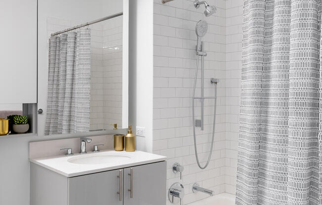 Modern one bedroom apartment bathroom shower with dual head showerhead and white tiles in brooklyn