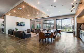 A modern living room with a wooden floor and a large window.