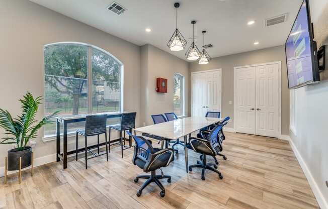 a conference room with a table and chairs and a large window