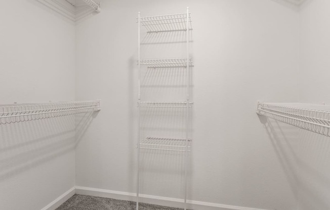 a room with two white closets and a white wall