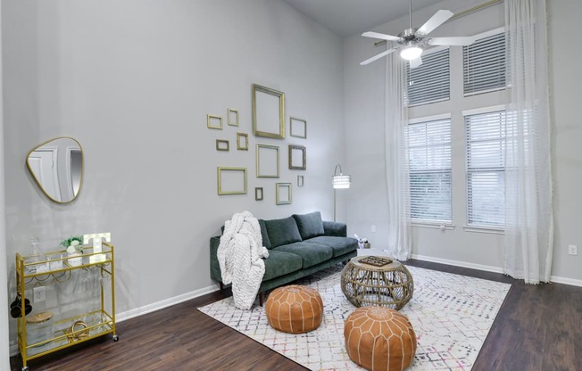 a living room with a couch and a ceiling fan