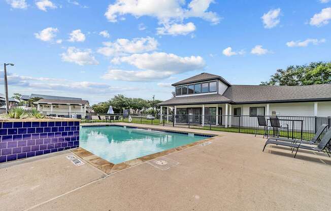A blue wall borders a rectangular pool.