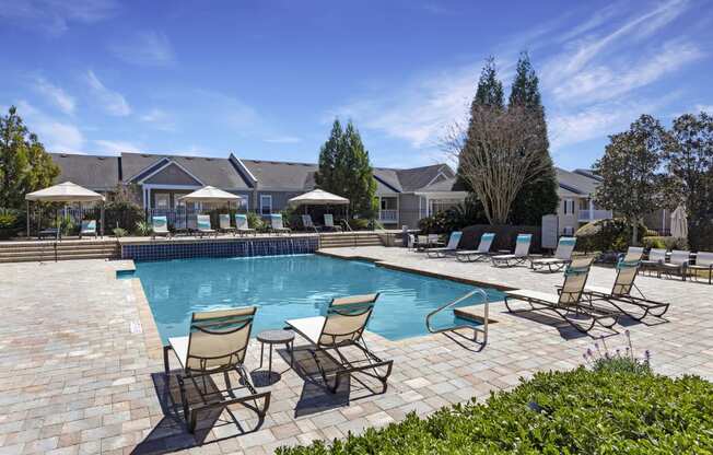 Sparkling swimming pool with fountain and large sundeck at Adrian on Riverside in Macon, GA