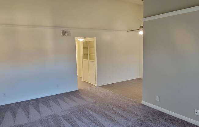 Living room view of dining room and hallway with storage space at Northwood Apartments in Upland, California.