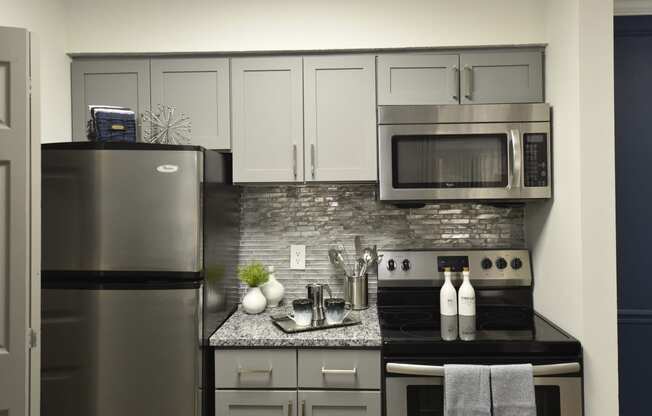 a kitchen with stainless steel appliances and a granite counter top