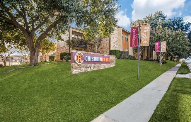A Chisholm sign is displayed in front of a building.