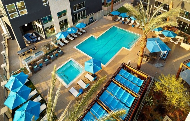 a poolside view of a resort with pools and umbrellas