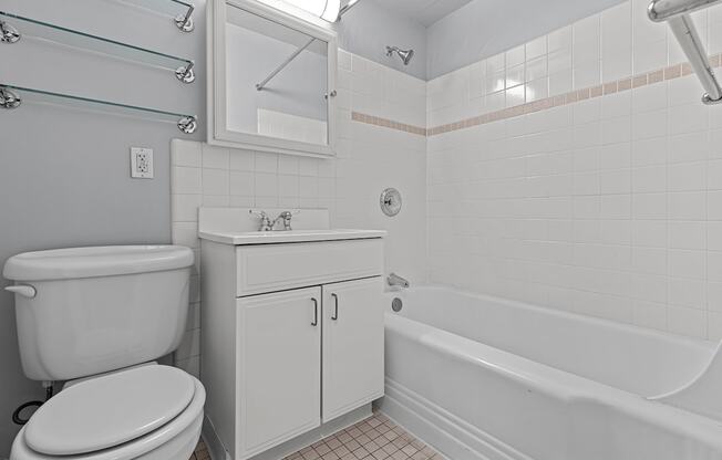 A white toilet sits next to a sink in a bathroom.