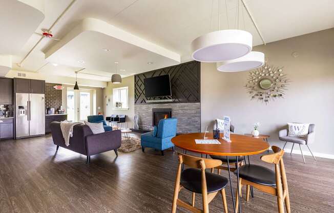 A modern living room with a fireplace and a dining table set up.