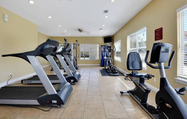 A gym with treadmills and exercise bikes.