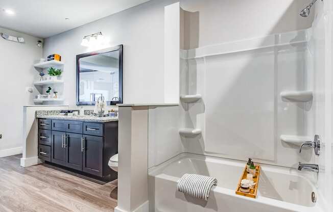 a bathroom with a shower and a sink and a bath tub