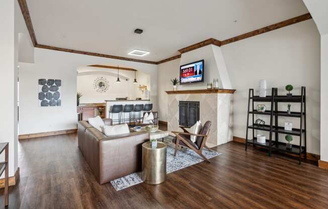 a living room with a leather couch and a fireplace