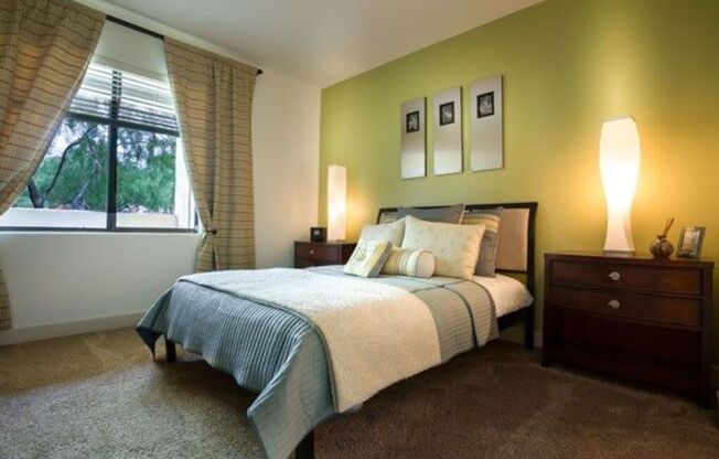 a bedroom with a bed and a lamp and a window at Canyon Crossroads in Phoenix, AZ 85085