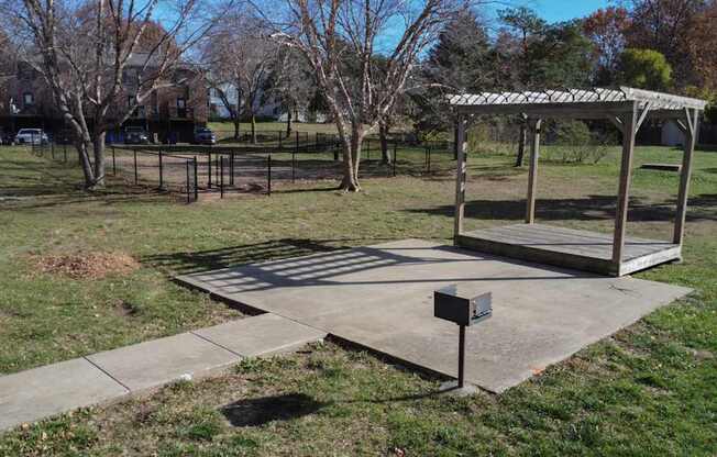 A park with a gazebo and a mailbox.