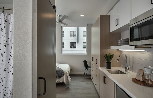 a bedroom with a large window in a 555 waverly unit