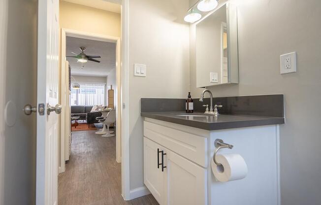 a kitchen with a sink and a mirror