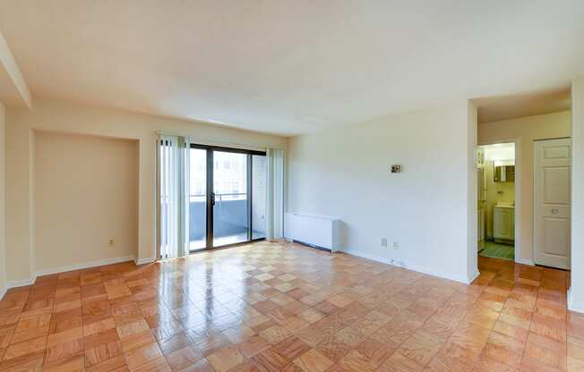 vacant living area with glass doors to balcony at twin oaks apartments columbia heights washington dc