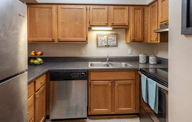 a kitchen with wooden cabinets and stainless steel appliances