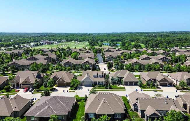 A suburban neighborhood with rows of houses and a clear blue sky.