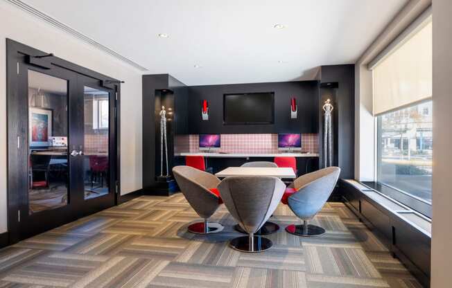 a dining room with a table and chairs and a tv on the wall