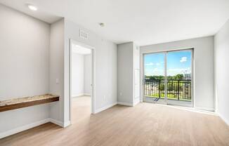 a living room with a large window and a balcony