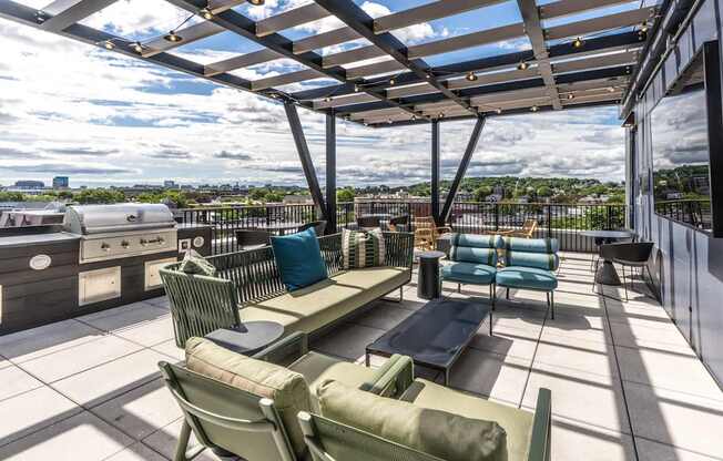 A patio with a table and chairs overlooking a cityscape.