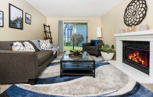 a living room with a fireplace and couches Copper Ridge Apartments, Renton, 98055