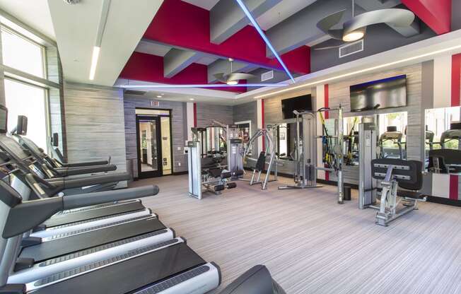 a spacious fitness center with treadmills and other exercise equipment