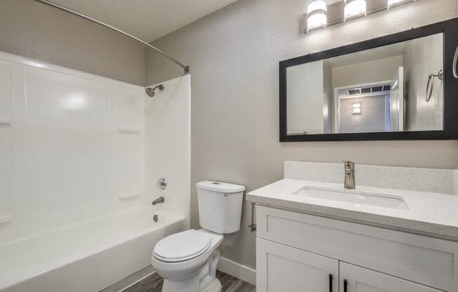A white toilet sits next to a sink in a bathroom.
