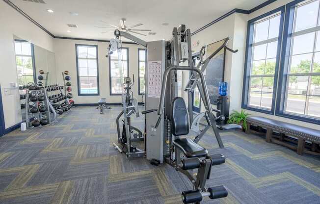 A gym with a variety of equipment including a leg press machine.