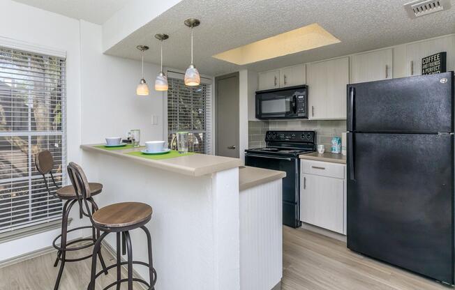 WELL-LIT BREAKFAST BAR WITH LARGE KITCHEN PANTRY