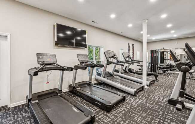 A gym with treadmills and other exercise equipment.