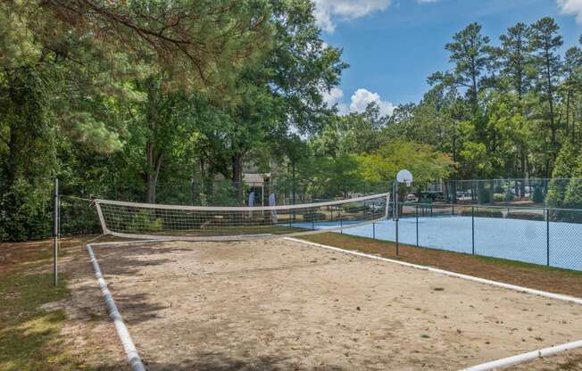 the tennis court is equipped with a net and a pool