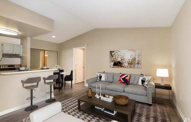 a living room with a couch and a coffee table at Aqua Bay Apartments in Naples, FL 34116