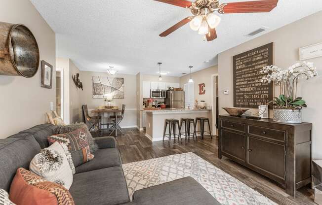 a living room with a couch and a kitchen in the background