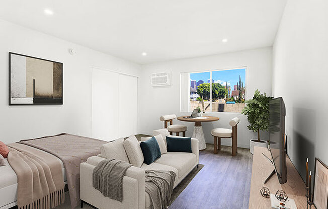 A living room with a couch, a chair, a television, and a window.