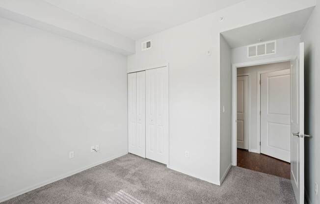 A room with a carpeted floor and white walls.