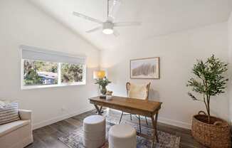 a living room with white walls and a table with chairs