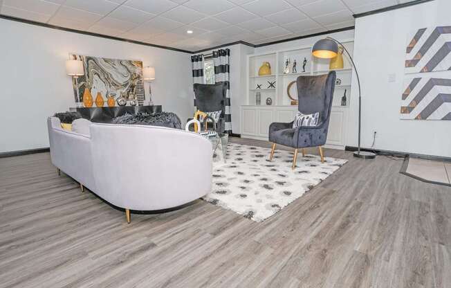 Clubhouse lounge area with large couch at Maplewood apartments in Shreveport, LA.