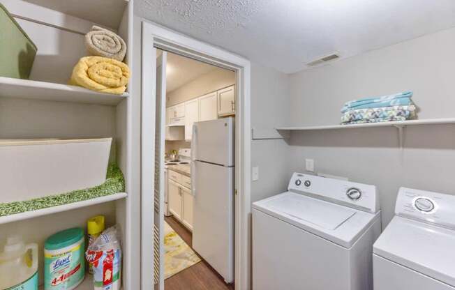 A laundry room with a white washer and dryer.