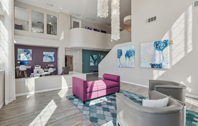 a lobby with couches and chairs and a chandelier