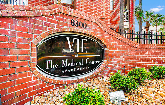 a brick wall with a sign for the medical center apartments