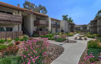 a colorful flower garden in front of a house