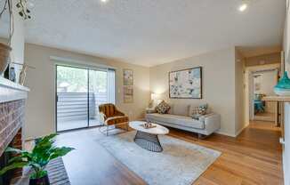 a living room with a couch and a chair and a sliding glass door