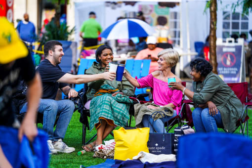 a group of people sitting on the grass