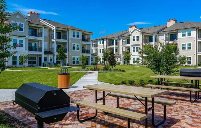 Outdoor Gathering Space with BBQ Grills and Outdoor Seating at Oasis Shingle Creek in Kissimmee, FL